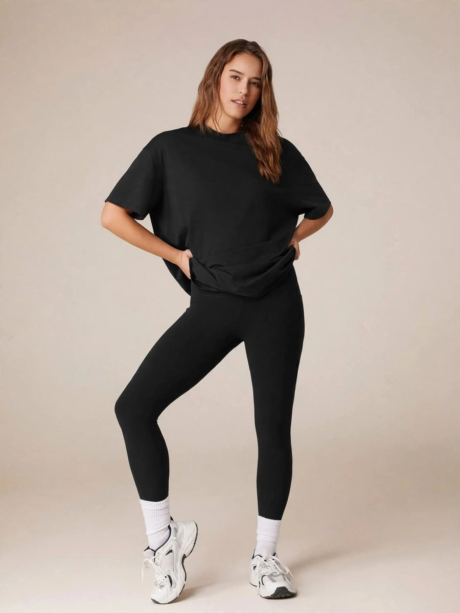 Model wearing the black oversized tee and leggings set